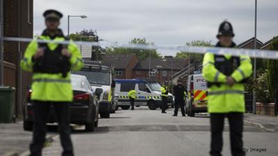 Police officers guard a street in Manchester