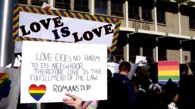 protest signs supporting LGBTQ teachers