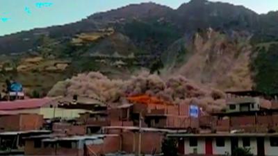 A cloud of dirt rising above a town