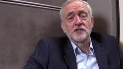 Jeremy Corbyn sitting on the floor of a train