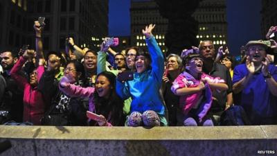 People wave to Pope Francis as he passes by in Philadelphia