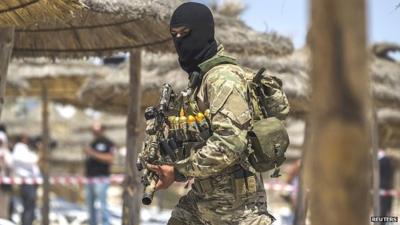 A member of Tunisia's special forces inspects the beaches