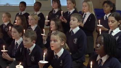 children's school choir holding candles