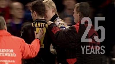 Manchester United's Eric Cantona gets taken away by steward