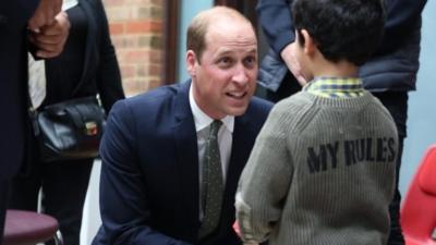 Duke of Cambridge speaks to a young boy