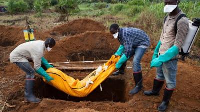 A victim of Ebola is buried in Sierra Leone in 2014