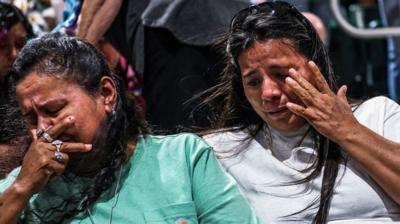 People cry at the vigil in Texas