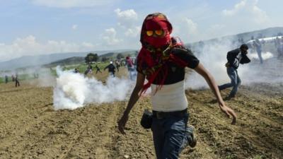 People fleeing clouds of tear gas