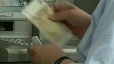 Man taking money from cash machine