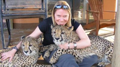 Dr Amy Dickman with two big cats