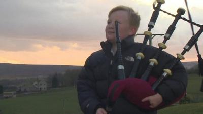 Boy holding bagpipes