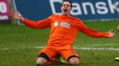 Sean Ward celebrates opening the scoring for Linfield against Ballymena United