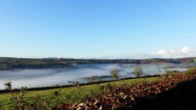 Mist in a valley with clear skies above