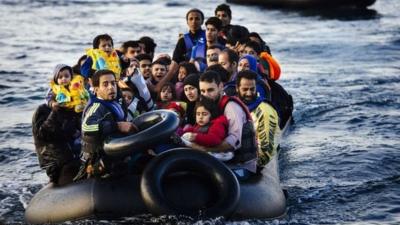 Migrants and refugees arrive on a dinghy on the Greek island of Lesbos, after crossing the Aegean sea from Turkey, on October 14, 2015