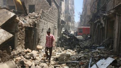 A man walks through the rubble of Aleppo, Syria