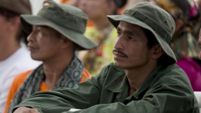 Rebels of the Revolutionary Armed Forces of Colombia, FARC, watch the signing of the peace accords during an event organized by rebels of the Revolutionary Armed Forces of Colombia, FARC, in the Yari Plains of southern Colombia, as they watch live images of government and FARC leaders signing a peace agreement in Cartagena to end more than five decades of conflict, Monday, Sept. 26, 2016.