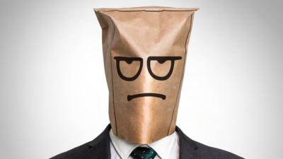 Businessman with a bag on the head with sad face