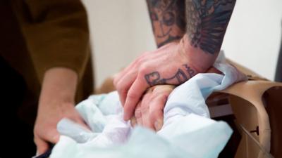 Hands doing chest compressions on a dummy