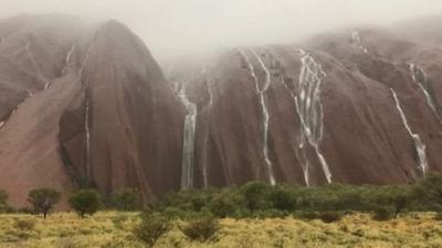 Water cascades Uluru after record breaking rainfall