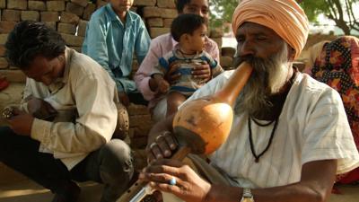 A former snaker charmer playing the pipe