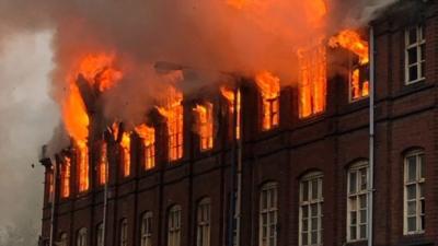 Warehouse engulfed by flames