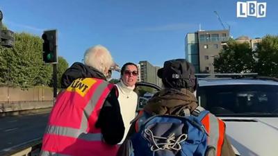 Woman confronts protesters