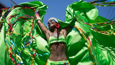 A reveler performs at the 'Carmelitas' block party during Carnival celebrations in Rio de Janeiro, Brazil, Friday, Feb. 5, 2016.