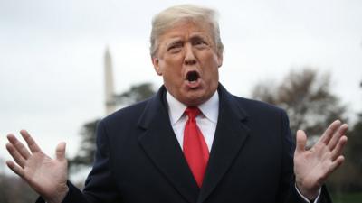 President Donald Trump answers questions from the press while departing the White House in Washington DC on 26 November 2018