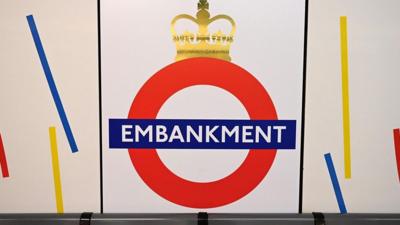 Shot of Embankment Station sign with crown on top