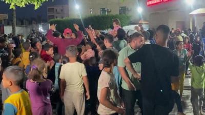 People celebrate outside Al Aqsa hospital