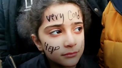 A child in a migrant camp along the border of Poland and Belarus