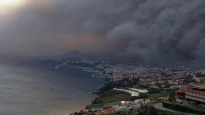 Billowing black smoke over Madeira coastline