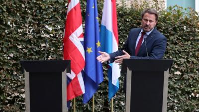 The UK prime minister did not attend a planned press conference in Luxembourg after protesters gathered outside.