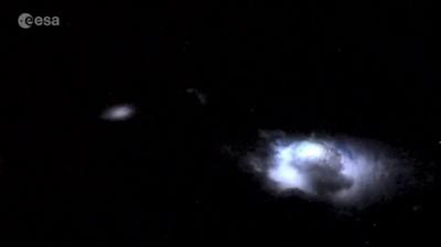 A thunderstorm viewed from above with blue jets emerging from the clouds