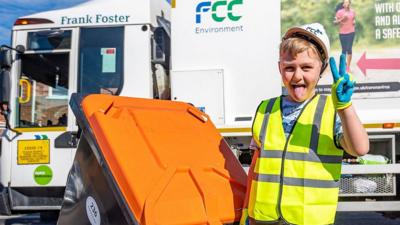 Frank Foster dragging a wheelie bin