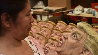 Mexican woman inspects Trump mask