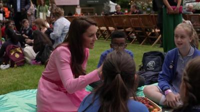 Princess of Wales at Chelsea Flower Show picnic talking to kids.