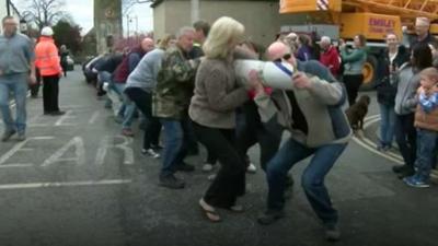 Residents moving the maypole