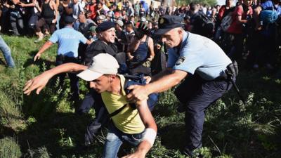 Migrants force their way through police lines at Tovarnik station