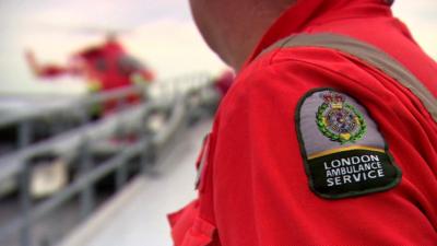 Paramedic looks at the London Air Ambulance helicopter