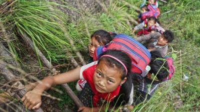 Chinese schoolchildren climbing ladder