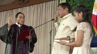 Rodrigo Duterte (centre) is sworn in as president of the Philippines