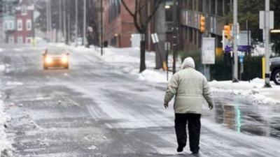 A man tried to walk up a snowy road in the US after a heavy snow storm