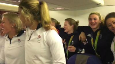 Some of Team GB singing the national anthem on the plane - still from footage filmed by Asha Philip