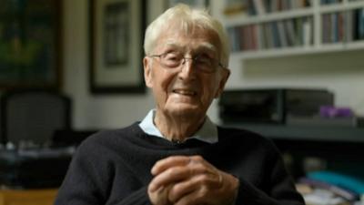 Sir Michael Parkinson smiling at camera