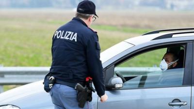 Italian police and person in car