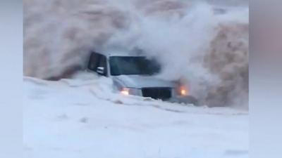 Car being submerged in the waves