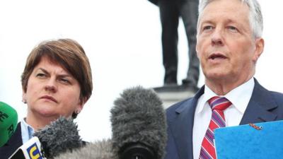 Northern Ireland First Minister Peter Robinson (r) speaking outside Stormont