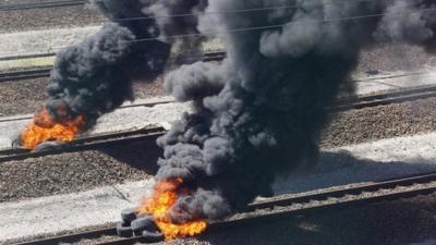 Burning tyres on Eurotunnel tracks near Calais