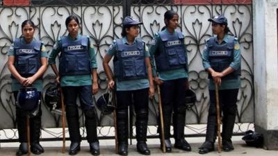 Members of the Bangladeshi police forces stand guard